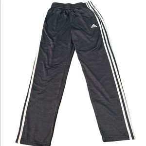Dark grey adidas 3 stripe joggers.